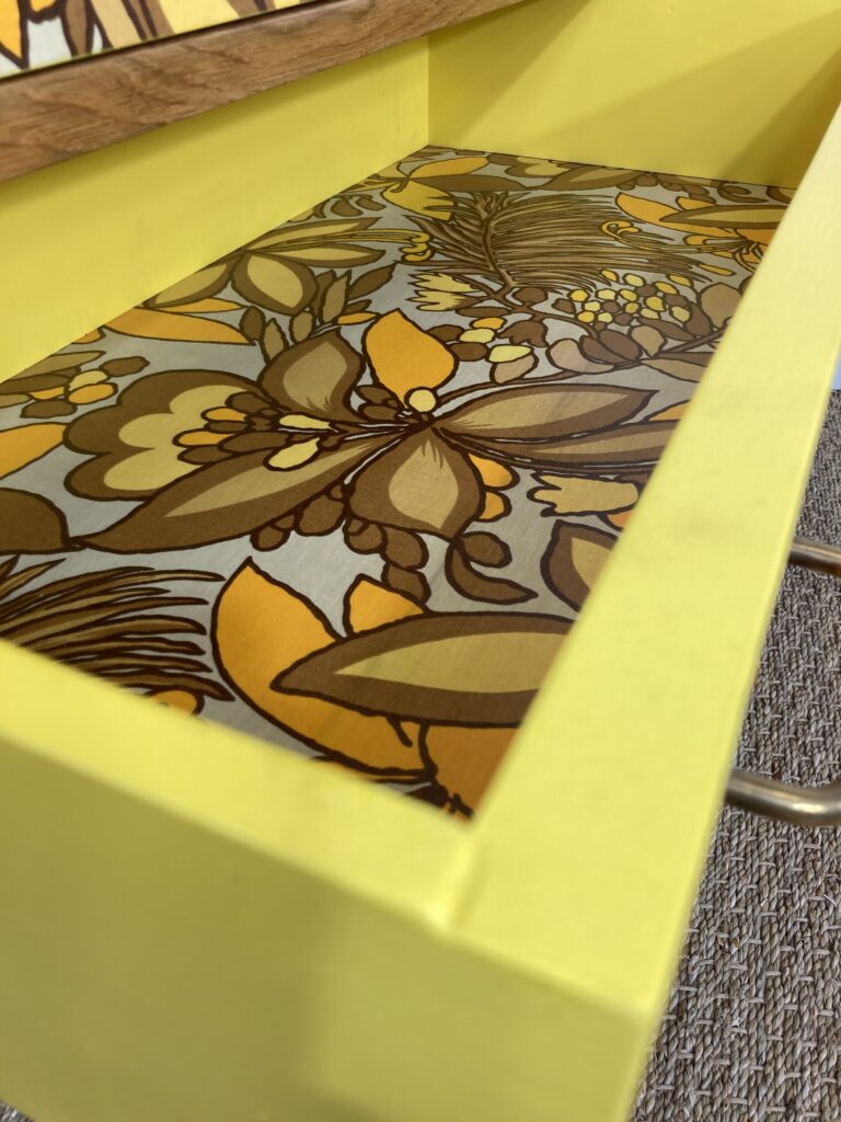 Intérieur d'un tiroir habillé de tissu à motif floral